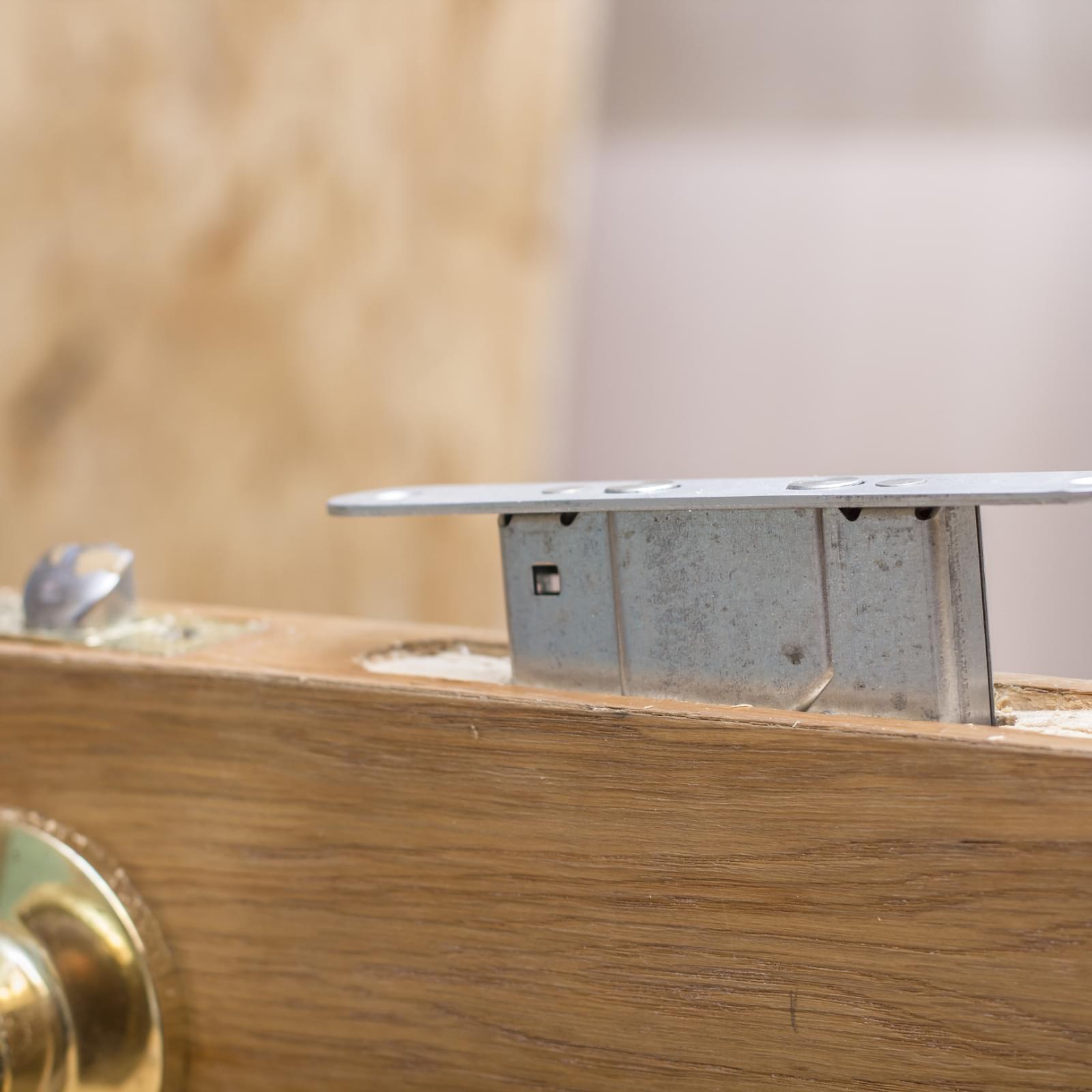 close up of a mortice deadlock being installed in a wooden door